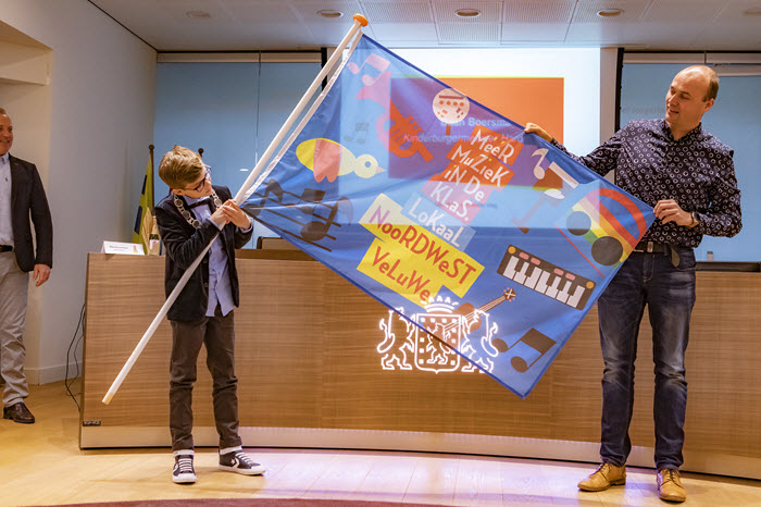 Kinderburgemeester van Harderwijk Daan Boersma met de winnende vlag van de Gabrielschool Putten.